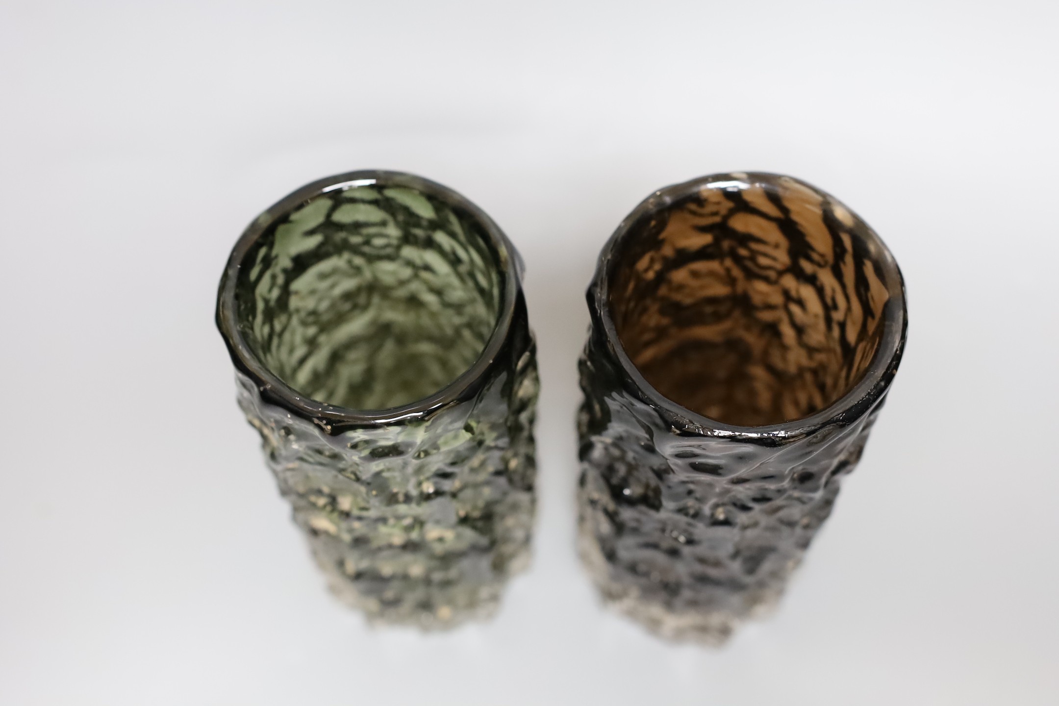 Two Whitefriars 'bark' cylinder vases, model 9689 designed by Geoffrey Baxter in 'sage' and 'cinnamon' glass, each 19cn high.